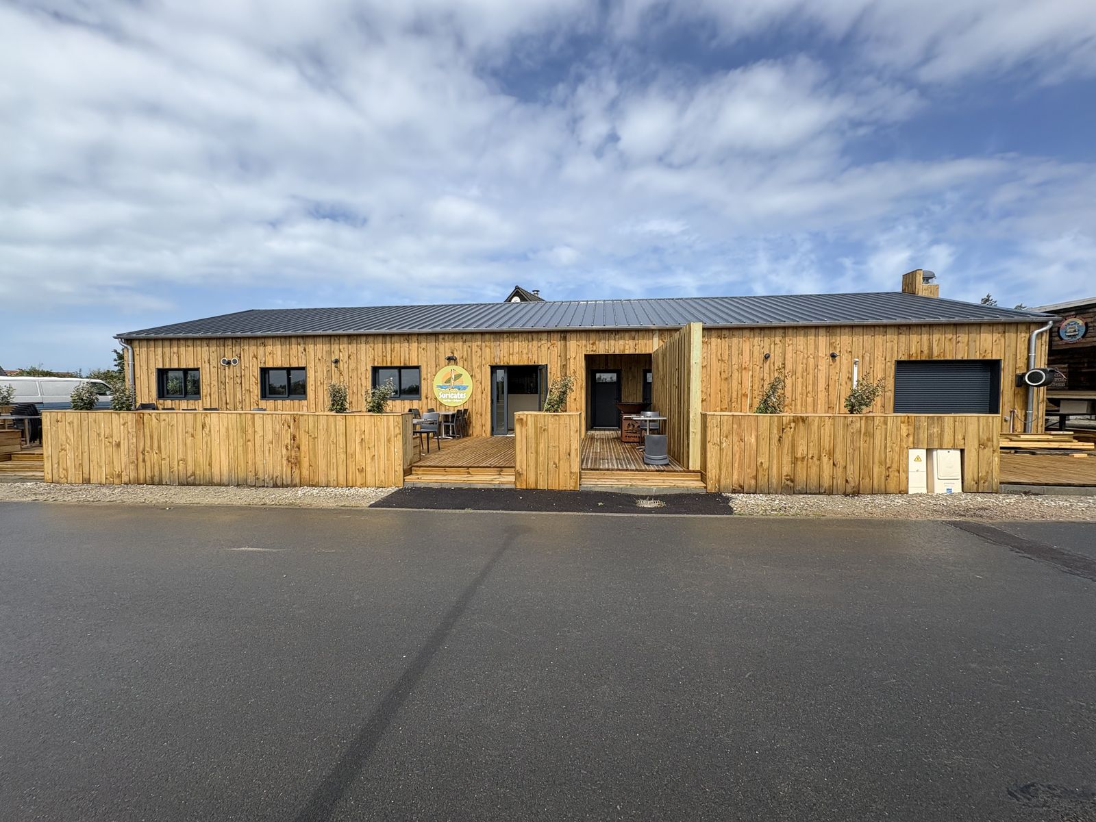 The wooden front of Les Suricates seen from the road, so you can spot the building as you arrive.