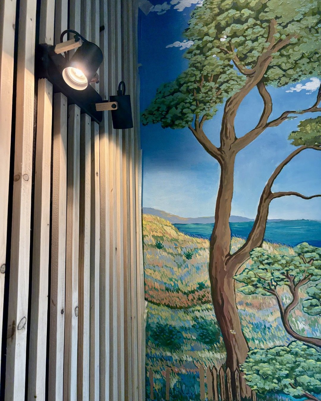 The mural of dunes and pine trees painted on the dining room wall.